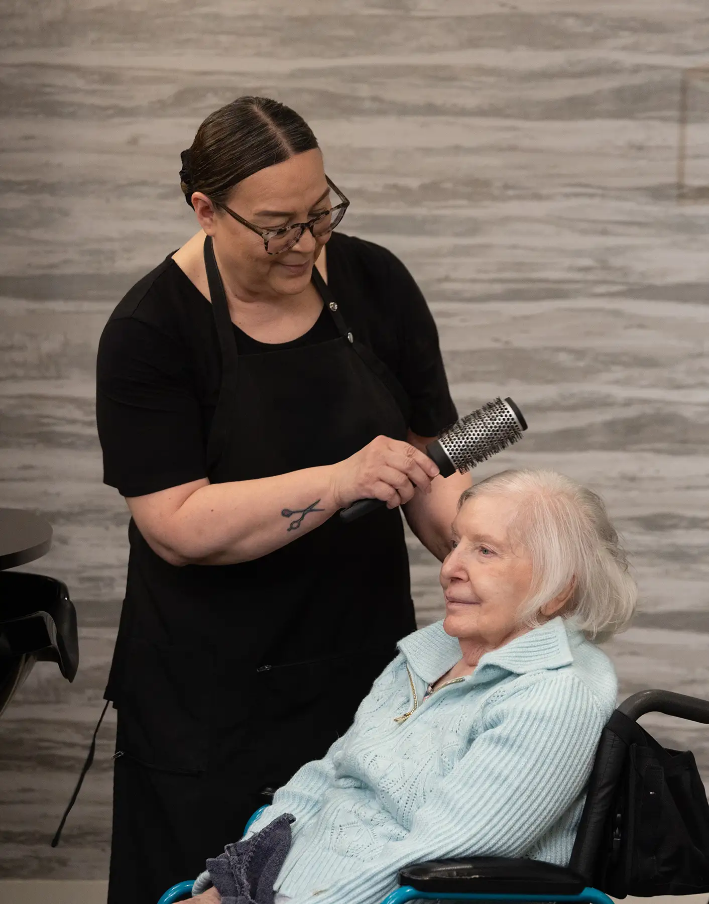 Resident getting her hair styled in the salon