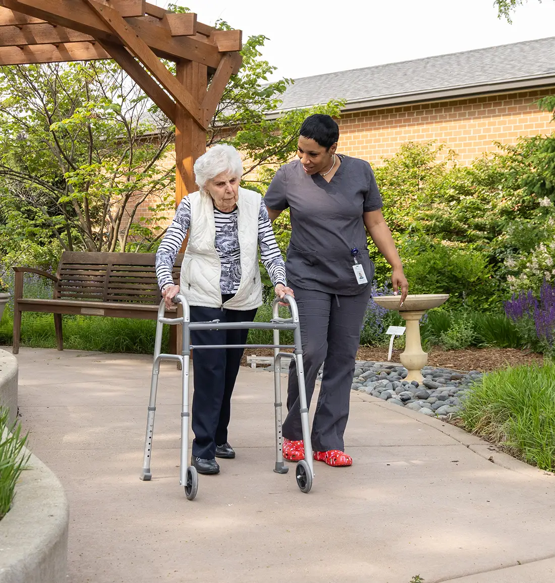 CNA assisting a resident outdoors